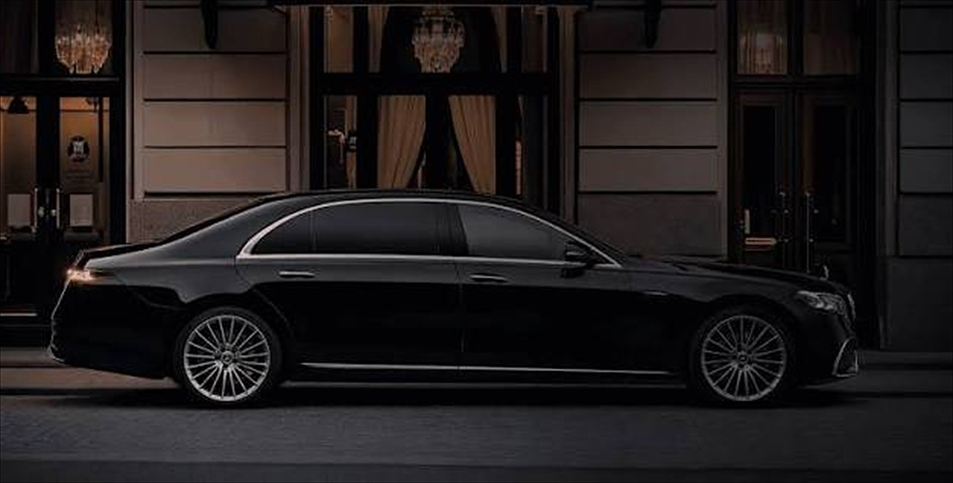Black Mercedes-Benz S-Class at a hotel entrance at night, Washington DC chauffeur service