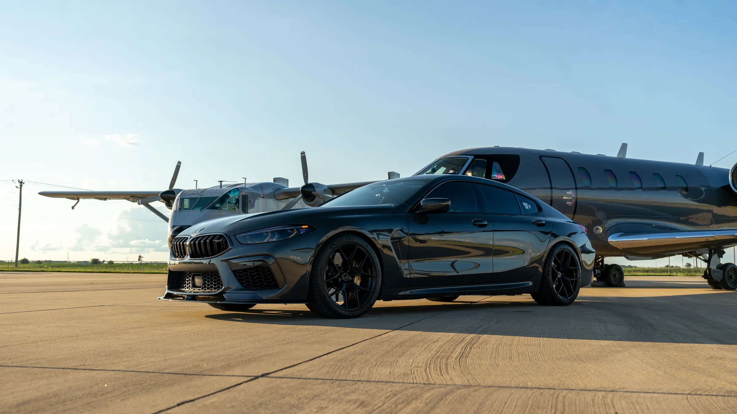 Conference & Event Transportation 2 Black executive saloon waiting beside a private jet on the airfield