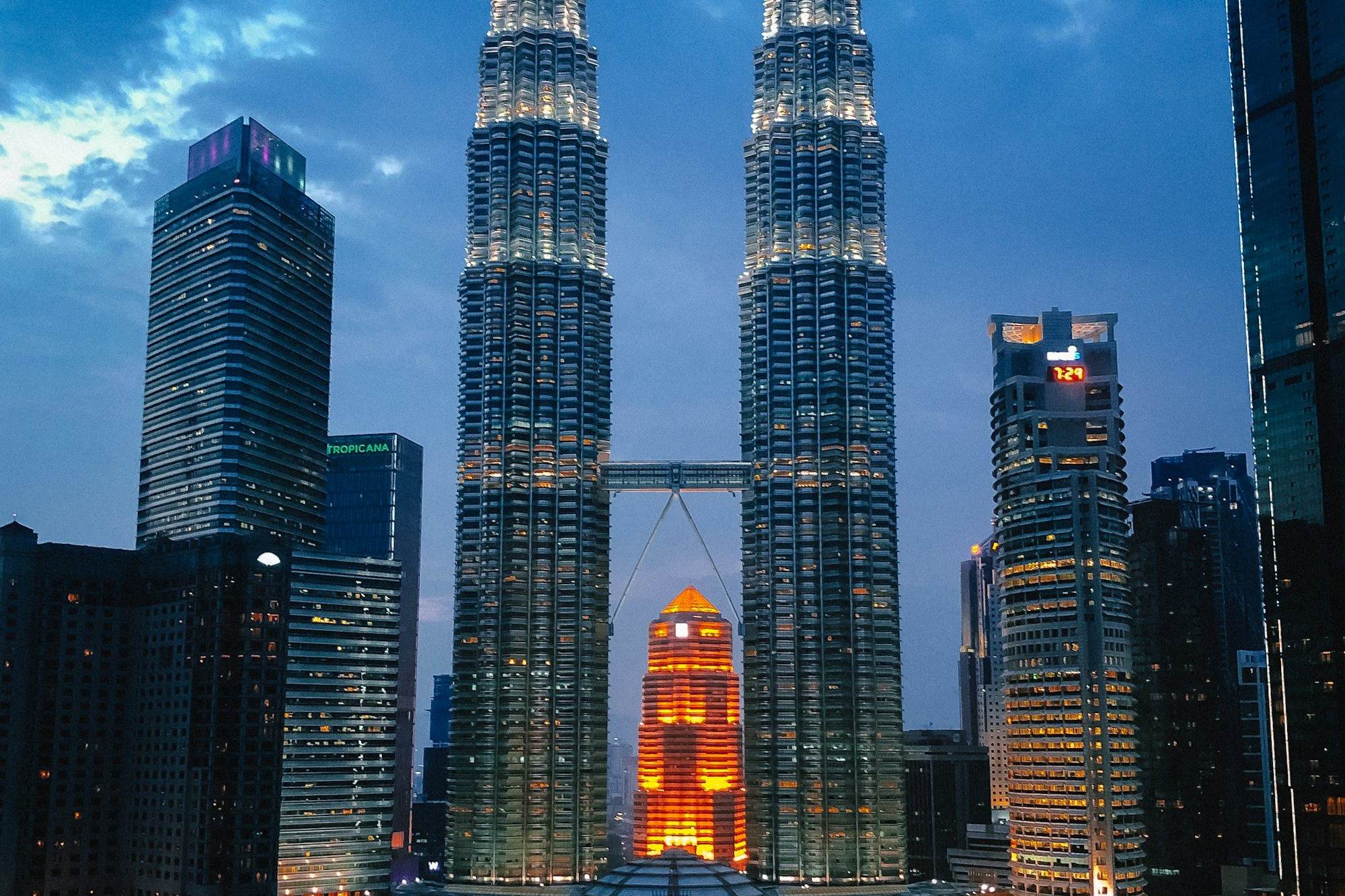 The Petronas Twin Towers lit up at dusk in Kuala Lumpur