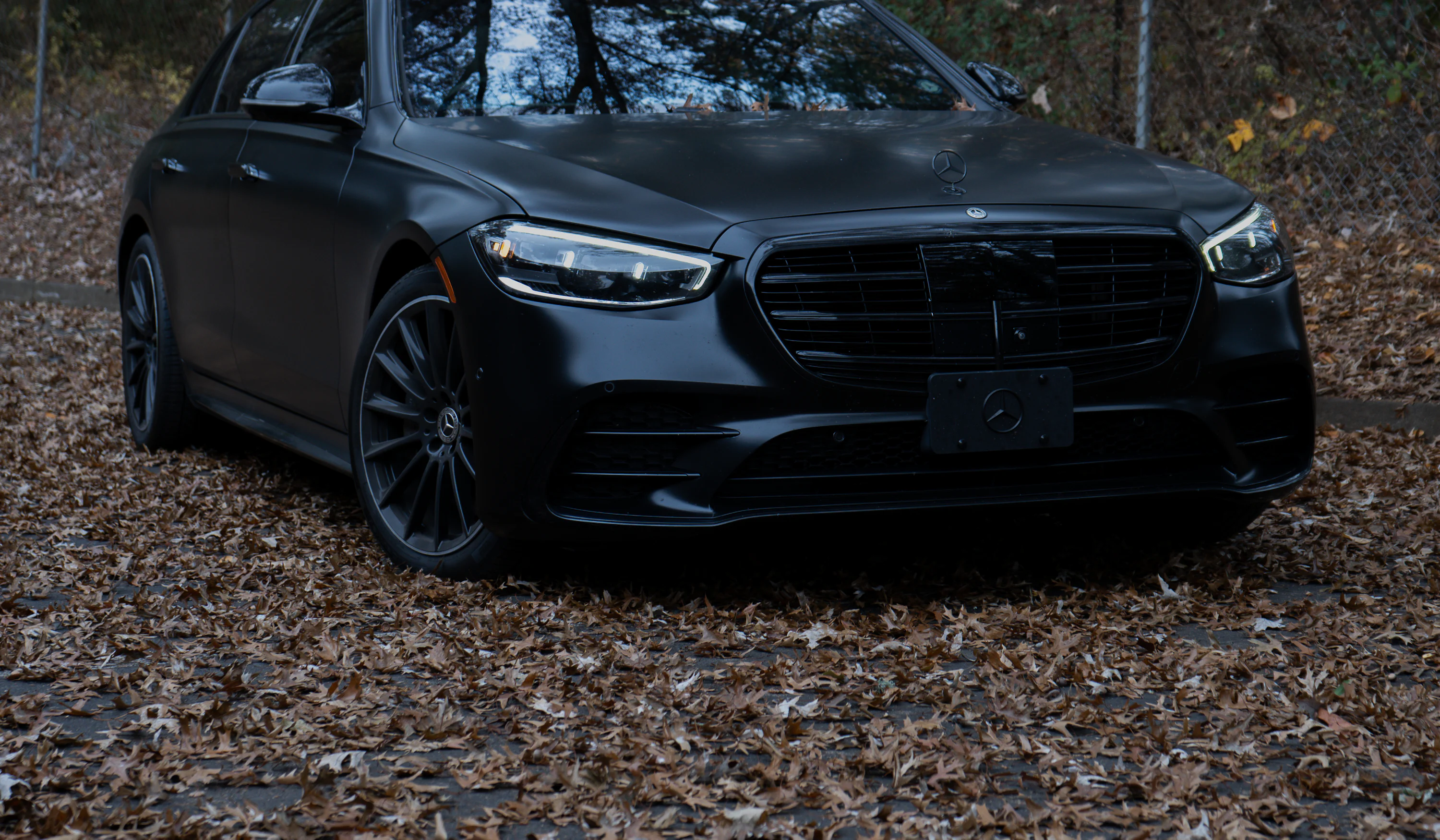 About Us 1 Black Mercedes-Benz S-Class with a chauffeur at the rear door
