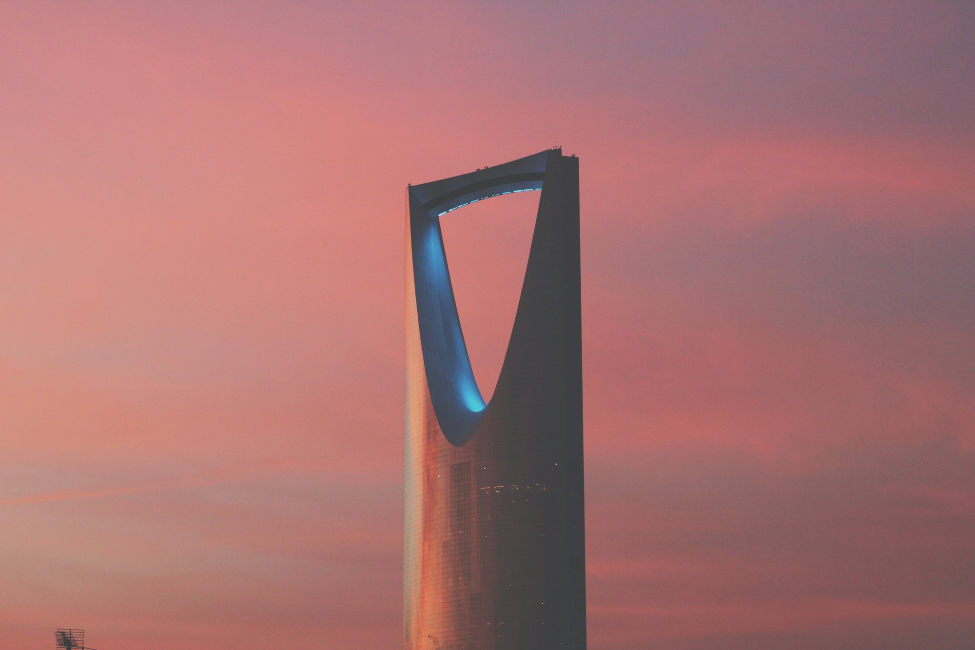 Kingdom Centre tower in Riyadh against a pink evening sky